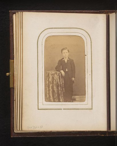 Portrait of a standing boy at a table