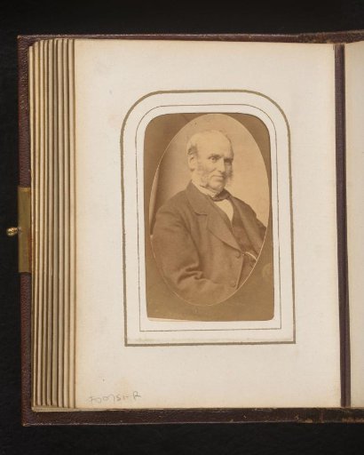 Portrait of a seated man with sideburns