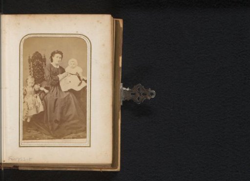 Portrait of a seated woman with a baby and a standing girl with a hoop