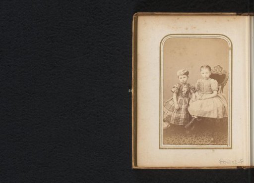 Portrait of two girls, one seated and the other standing