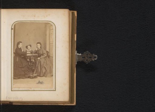Portrait of two seated women and a girl at a chess game