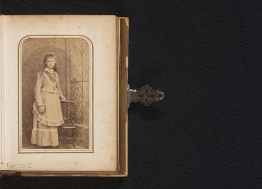 Portrait of a girl by a chair