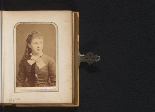 Portrait of a girl with long hair and a bow