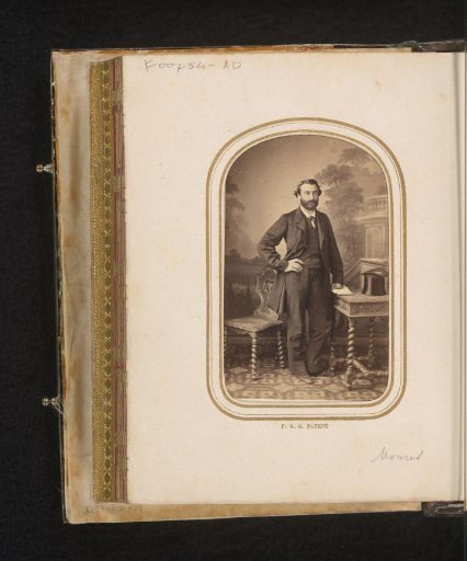 Portrait of a man, standing at a table with a hat