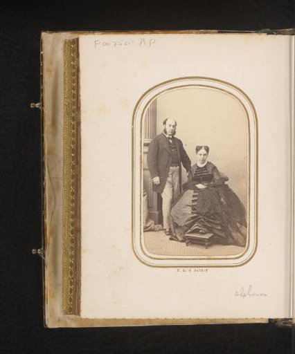 Portrait of a standing man with sideburns and a seated woman