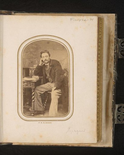 Portrait of a Seated Man at a Table with Books and Hat
