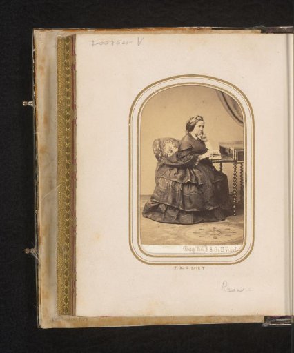 Portrait of a Woman, Seated at a Desk with Photo Album