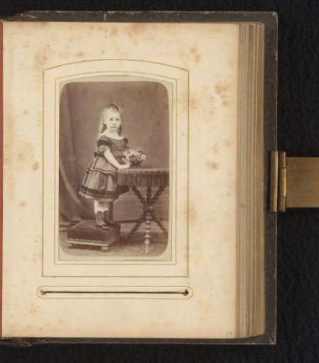 Portrait of a girl standing by a table