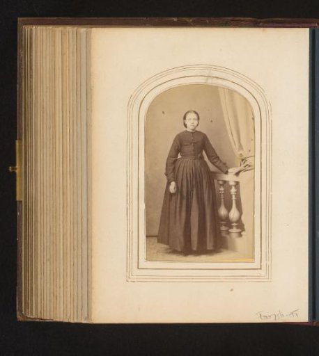 Portrait of a woman, standing by a balustrade