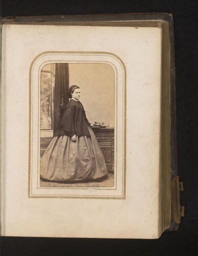 Portrait of a Young Woman Standing by a Cabinet