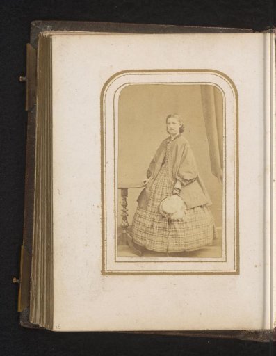 Portrait of a Woman with a Hat in Her Hand, Standing by a Table