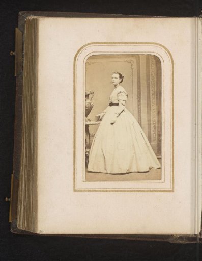 Portrait of a Woman with a Book in Her Hand, Standing by a Table