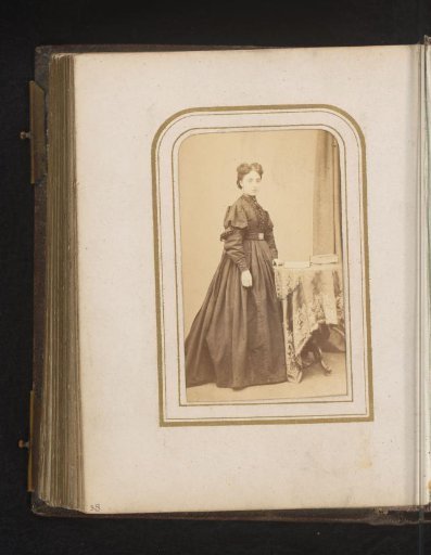 Portrait of a Woman Standing by a Table with Books