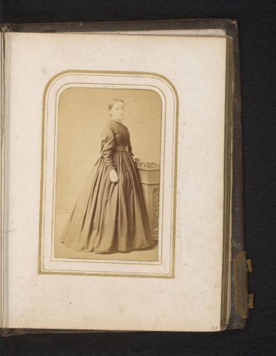 Portrait of a Woman Standing by a Piece of Furniture