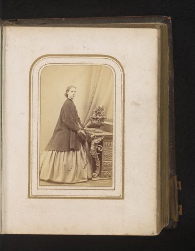 Portrait of a woman, standing by a table with flowers