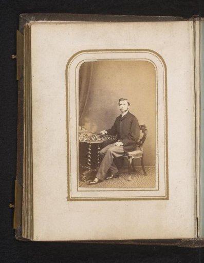 Portrait of a man, sitting at a table
