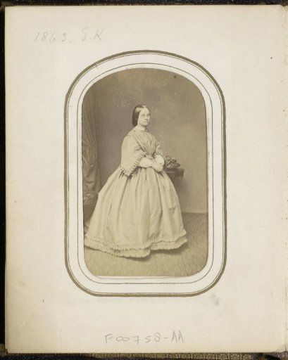 Portrait of a woman at a table with a basket, inscribed E.K.