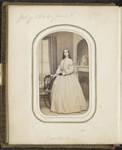 Portrait of a woman standing by a fireplace, inscribed Jane K.