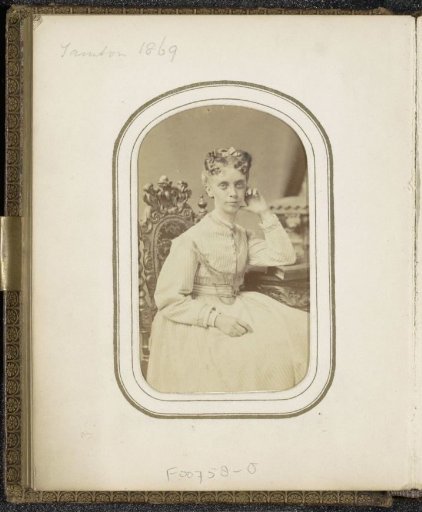 Portrait of a seated woman in a striped dress