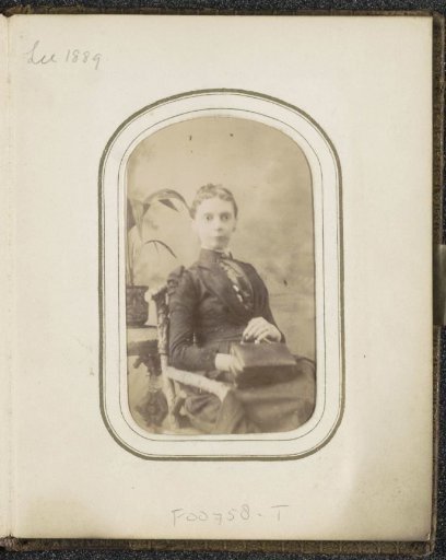 Portrait of a woman with a bag on her lap