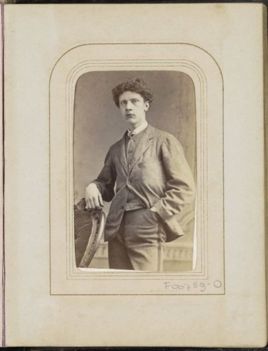 Portrait of a young man at a chair