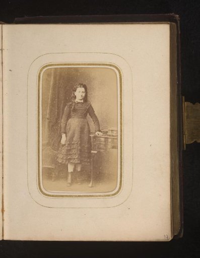 Portrait of a girl, standing by a desk
