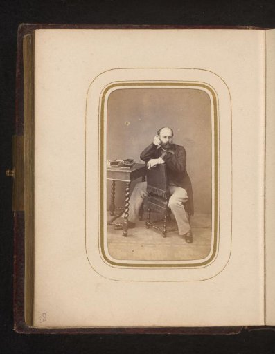Portrait of a seated man with a beard