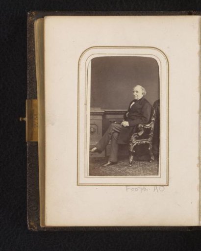 Portrait of a seated man with gloves