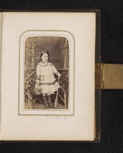 Portrait of a girl with wooden bucket and shovel