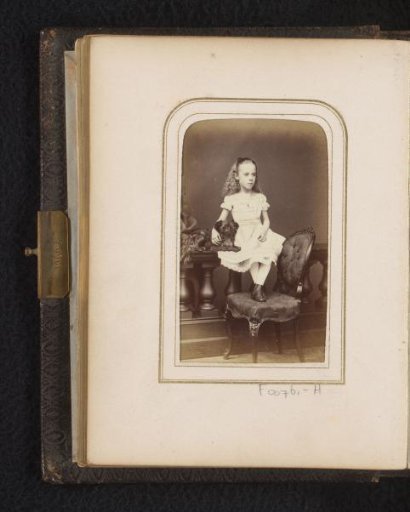 Portrait of a girl, sitting with dog on a balustrade