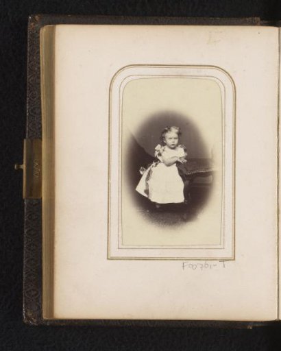 Portrait of a girl, standing by a chair
