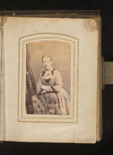 Portrait of a young woman, leaning on a chair