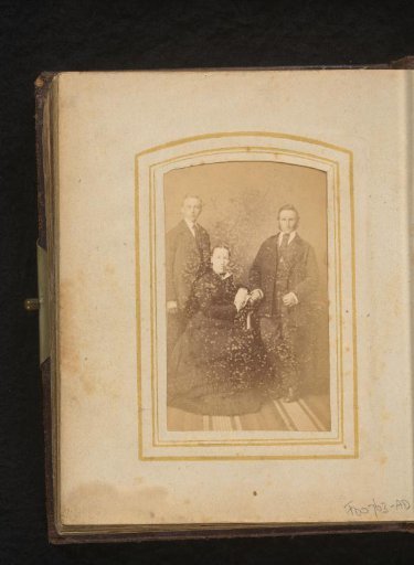 Portrait of a seated woman and two standing men