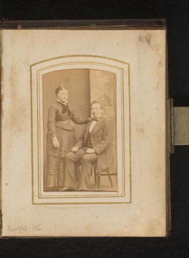 Portrait of a standing woman and a seated man