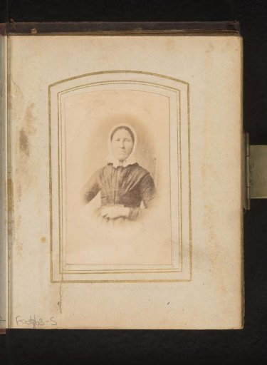 Portrait of a woman with a white costume cap