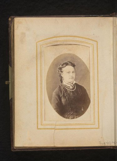 Portrait of a seated woman with a necklace