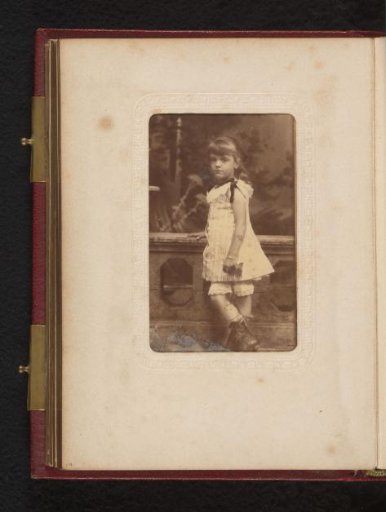 Portrait of a girl, standing by a balustrade
