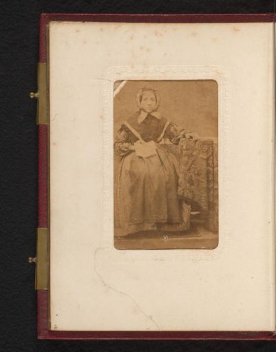 Portrait of a Woman with a Cap, Seated at a Table