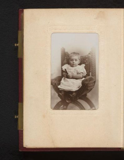 Portrait of a toddler, seated in a high chair