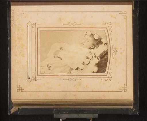Post-mortem portrait of a girl, surrounded by flowers