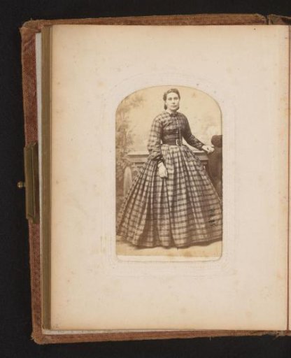 Portrait of a woman standing by a balustrade