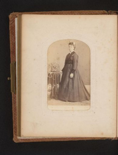 Portrait of a woman standing by a table with a plant