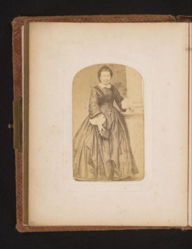 Portrait of a woman standing by a balustrade