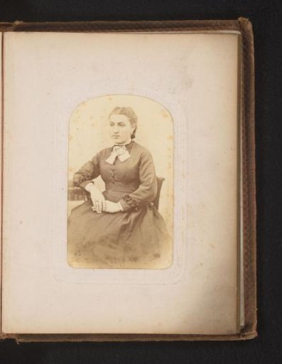 Portrait of a woman seated at a table