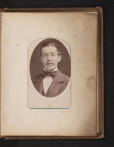 Portrait of a man with a moustache and a bow tie