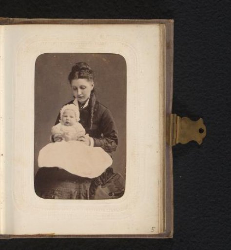 Portrait of a young woman with a baby on her lap