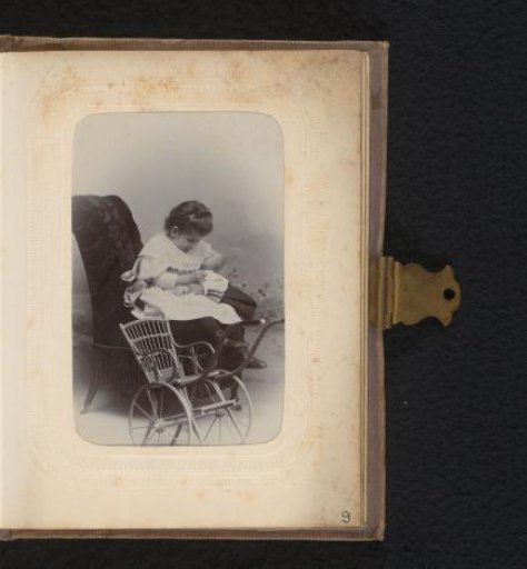 Portrait of a girl in a chair, with a wheelchair in the foreground
