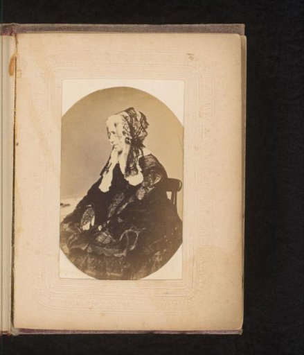 Portrait of a seated woman in black with lace cap, in profile