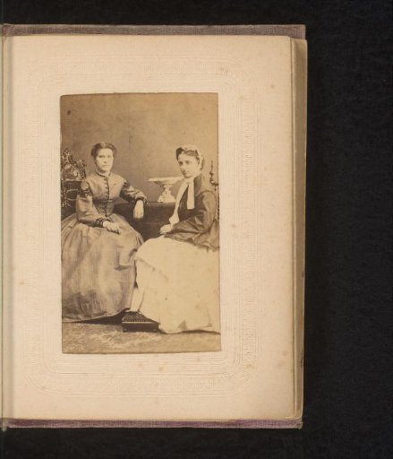 Portrait of a woman and a maid, seated at a table