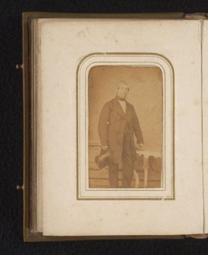Portrait of a Standing Man Holding a Hat